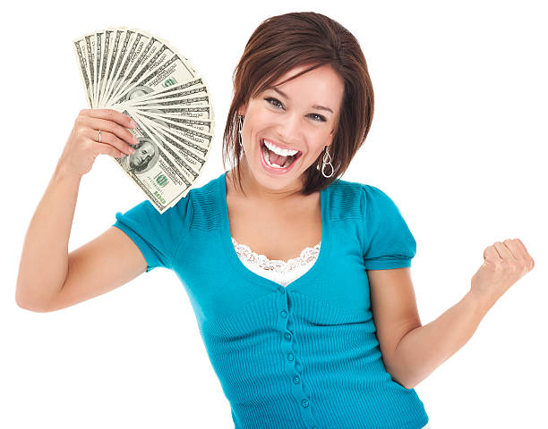 Woman celebrating with a fan of cash from selling her junk car